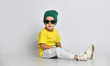 hipster kid boy sitting on floor