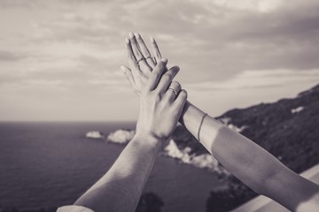 Poster - Grayscale shot of the hands of a male and female with engagement rings