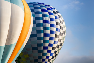 Multiple colorful Hot Air Balloons in clear blue sky.