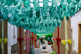 Fototapeta  - Street fully decorated with multicolored paper in Redondo village, Alentejo region, Portugal.
