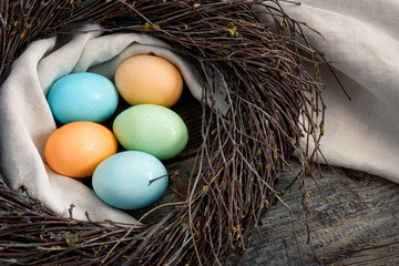 Multicolored eggs in a nest.