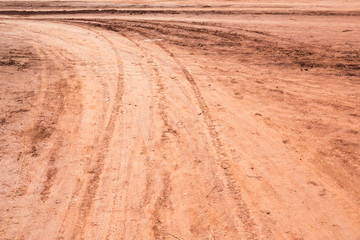 Wall Mural - Curved rut background texture on hard dry dirt road