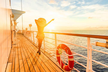 Luxury cruise ship travel elegant woman having fun carefree on deck enjoying watching sunset on Europe cruising destination vacation. Summer european mediterranean cruiseship sailing away on holiday.