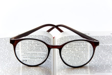 Open Holy Bible In Bahasa Indonesia (Yeremia 29:11) On White Background With Glasses Close Up