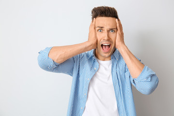 Sticker - Stressed young man on light background