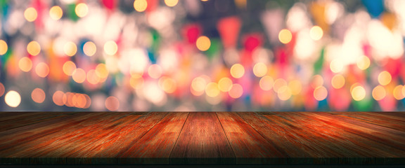 top desk with blur restaurant background,long wooden table and blurred bokeh of night street background