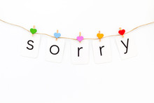 Apologise Concept. Cute Heart Icons Garland With Text Sorry On White Background Top View Copy Space