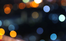 Abstract Bokeh Of City Lights Defocused On Black Background In Various Colors