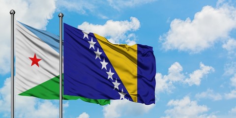 Djibouti and Bosnia Herzegovina flag waving in the wind against white cloudy blue sky together. Diplomacy concept, international relations.