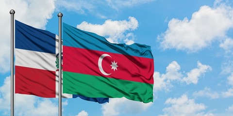 Dominican Republic and Azerbaijan flag waving in the wind against white cloudy blue sky together. Diplomacy concept, international relations.