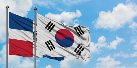 Dominican Republic and South Korea flag waving in the wind against white cloudy blue sky together. Diplomacy concept, international relations.