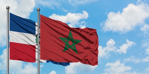 Dominican Republic and Morocco flag waving in the wind against white cloudy blue sky together. Diplomacy concept, international relations.