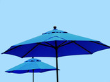 Fototapeta Tęcza - Blue market umbrella isolated on blue sky