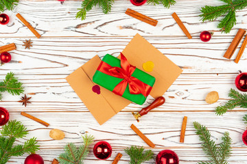 Wall Mural - Wrapped present on a wooden background with Christmas holiday decorations top view