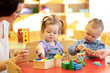 © Oksana Kuzmina - Children play with a teacher in nursery or kindergarten