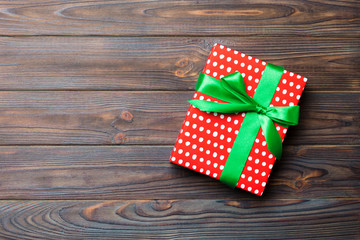 Top view of christmas or other holiday handmade present box package, flat lay dark wooden background with copy space. new year gift box