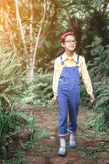 Canvas Print - cute child girl with glasses walk in summer garden