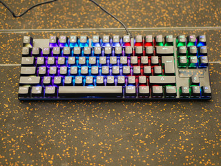 multi-colored keyboard. mechanical keys. Multi-colored professional gaming mechanical rgb keyboard on the table background 