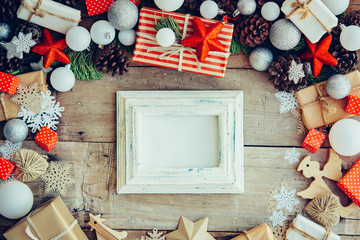 Wall Mural - Christmas background with frame and gift boxes on the wooden tab