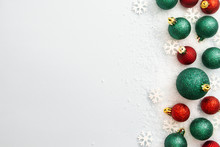 Christmas Glitered Green And Red Baubles, Balls Isolated On Snow. Winter Abstract Border Mockup.