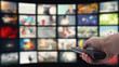 © olegkruglyak3 - Remote control in hand on the background of the TV
