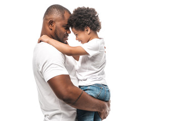 Wall Mural - happy african american man holding adorable son isolated on white