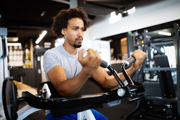 Wall Mural - Fitness, sport, exercising and lifestyle concep Young man working out in gym