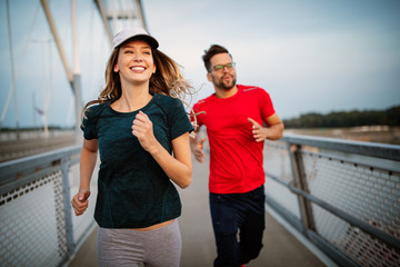 Sport couple. Young man and woman jogging outdoor