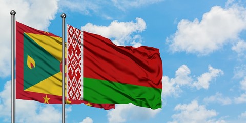 Grenada and Belarus flag waving in the wind against white cloudy blue sky together. Diplomacy concept, international relations.