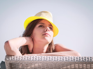 pretty caucasian girl in a straw hat lying on sunbed. beach vacation concept.