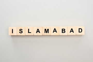 Wall Mural - top view of wooden blocks with Islamabad lettering on grey background