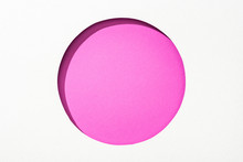 Cut Out Round Hole In White Paper On Bright Pink Colorful Background