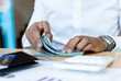 © Puwasit Inyavileart - .Counting money, businessmen have analyzed between cash and credit card which is consistent and convenient to spend in the present day.