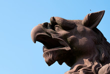 Sculpture: Brown Griffin Head Against The Sky.