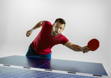 Traffic. Young Man Plays Table Tennis On White Studio Background. Model Plays Ping Pong. Concept Of Leisure Activity, Sport, Human Emotions In Gameplay, Healthy Lifestyle, Motion, Action, Movement.