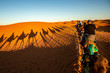 European tourists in Sahara Desert during sunset, Merzouga, Morocco
