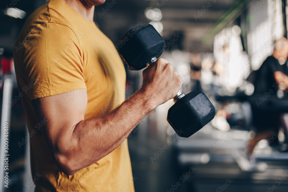 authentic image, detail close up of fit coach man lifting weight, training bicep curl in the gym. concept of weight loss and healthy living. - obrazy, fototapety, plakaty 
