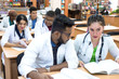 © Алексей Доненко - a multinational group of medical students, sitting at the table, studying medical literature