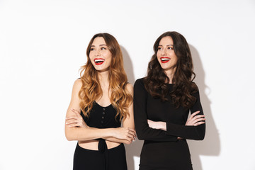 Sticker - Image of two alluring women in black outfit smiling and looking aside