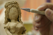Photography Of Clay - Stained Girl Doing The Figurine Of A Girl Wth Long Hair. Concepts Of Handicraft And Creativity