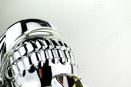 Fotomural Upside down teeth of a shiny chrome effect skull mask taken in a studio with studio lighting