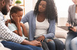 © Prostock-studio - Little black girl and her parents at psychologist consultation