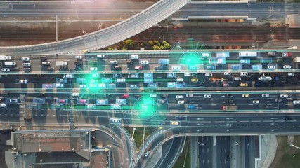 Wall Mural - Beautiful aerial presentation of the autonomous cars self-driving concept on multi-level highway on the sunny evening in Moscow with 3 cars and their trajectories highlighted. 