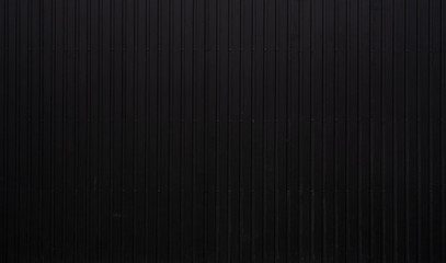 Wall Mural - Black Corrugated metal sheet texture surface of the wall. Galvanize steel background.