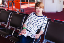 Woman Reading Newspaper At Charles De Gaulle Airport,