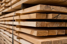 Piles Of Wooden Boards In The Sawmill, Planking. Warehouse For Sawing Boards On A Sawmill Outdoors. Wood Timber Stack Of Wooden Blanks Construction Material. Industry.