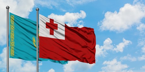 Kazakhstan and Tonga flag waving in the wind against white cloudy blue sky together. Diplomacy concept, international relations.