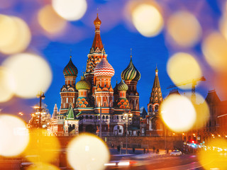 Wall Mural - Famous landmark - St. Basil Cathedral on Red square in Kremlin. Light bulbs bokeh. Moscow, Russia.