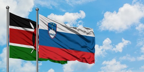 Kenya and Slovenia flag waving in the wind against white cloudy blue sky together. Diplomacy concept, international relations.