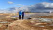 © Tommy Larey - A couple of tourists watching The Namafjall Geothermal Area, located in Northeast Iceland, on the east side of Lake Myvatn.